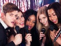 Friends Singing Into Microphones At Karaoke Party Royalty Free Stock Photo