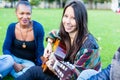 Friends singing songs in park having fun together