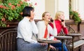 Friends sit in coffee shop and enjoy talk. Obsessed with speaking. Using digital devices. Group women cafe terrace Royalty Free Stock Photo