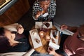 Friends sitting at a cafe table enjoying delicious desserts together Royalty Free Stock Photo