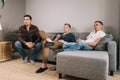 Friends are sitting on couch at home and have funny conversation Royalty Free Stock Photo