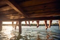 friends sitting on the dock of the bay and enjoying at sunset Royalty Free Stock Photo