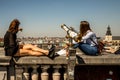 Friends sitting near a telescope near Infantry Memorial in the City of Brussels, Belgium Royalty Free Stock Photo