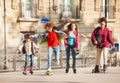 Friends skateboarding and rollerblading in city Royalty Free Stock Photo