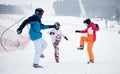 Friends skiers having fun at ski resort in the mountains in winter, skiing and snowboarding Royalty Free Stock Photo