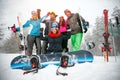 Friends skiers and snowboarders having fun on snowbound winter f
