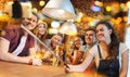 Friends with smartphone on selfie stick at bar Royalty Free Stock Photo