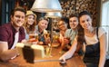 Friends with smartphone on selfie stick at bar Royalty Free Stock Photo