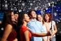 Friends with smartphone taking selfie in club Royalty Free Stock Photo