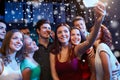 Friends with smartphone taking selfie in club Royalty Free Stock Photo