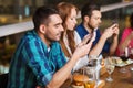 Friends with smartphones dining at restaurant Royalty Free Stock Photo