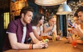 Friends with smartphones and drinks at bar Royalty Free Stock Photo