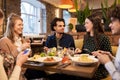 Friends with smartphones eating at restaurant Royalty Free Stock Photo