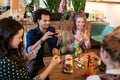 Friends with smartphones and food at restaurant Royalty Free Stock Photo