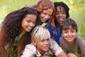 Friends, smile and group of children in field together for summer camp, adventure or outdoor fun. Diversity, grass and Royalty Free Stock Photo