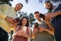 Friends smiling using mobile phones Royalty Free Stock Photo