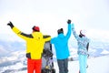Friends with snowboards at mountain resort. Winter vacation