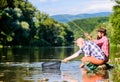 Friends spend nice time at riverside. Beautiful evening riverside. Experienced fisherman show tips to son. Transferring Royalty Free Stock Photo