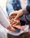 Friends stick together. Shot of a group of unrecognizable elementary school kids joining their hands together in a Royalty Free Stock Photo