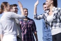 Friends students giving each other a high five. Royalty Free Stock Photo