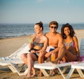 Friends sunbathing on a beach Royalty Free Stock Photo