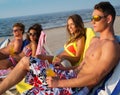 Friends sunbathing on a beach Royalty Free Stock Photo