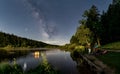 Friends are taking an outdoor bath in a lake under the nightly milkyway at a star clear night, beautiful summer scene.