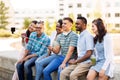 Friends taking picture by on selfie stick in city Royalty Free Stock Photo