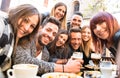 Friends taking selfie at bar restaurant drinking cappuccino and Royalty Free Stock Photo
