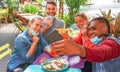 Friends taking selfie in a bar restaurant with face mask on in coronavirus time - Young people having fun with drinks and snacks Royalty Free Stock Photo