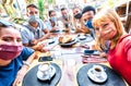 Friends taking selfie at coffee bar - People having fun together at cafeteria covered by face masks - New normal lifestyle concept Royalty Free Stock Photo