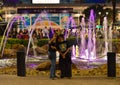 Friends taking selfie on magenta iluminated water fountain in International Drive area.