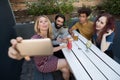 Friends taking selfie with mobile phone while having drinks in bar Royalty Free Stock Photo