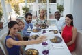 Friends taking selfie on mobile phone while having meal Royalty Free Stock Photo