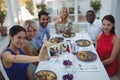 Friends taking selfie on mobile phone while having meal Royalty Free Stock Photo