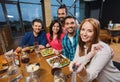 Friends taking selfie by smartphone at restaurant Royalty Free Stock Photo