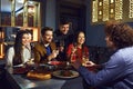 Friends talk fun at the table in the restaurant Royalty Free Stock Photo