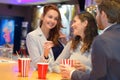 friends talking in cinema lobby