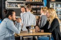 Friends Talking At Table In Bar Royalty Free Stock Photo