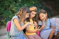 Three little girls using smart phone together