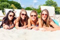 Friends tanning in beach bar on sand Royalty Free Stock Photo