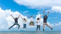 Friends and teamwork jumping on beach during sunset time for success business. Royalty Free Stock Photo