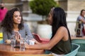 Two women in cafÃÂ© using smart phone Friends time Royalty Free Stock Photo