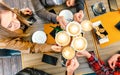 Top view of friends toasting cappuccino at coffee shop restaurant - Millennial students group having fun on breakfast together Royalty Free Stock Photo