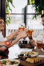 Friends toasting and drinking beer and cocktails in pub restaurant. Lifestyle party time concept Royalty Free Stock Photo