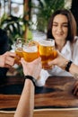 Friends toasting and having fun together drinking beer and cocktails in pub restaurant Royalty Free Stock Photo