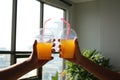 Friends toasting healthy juice drinks together in office shoot concept
