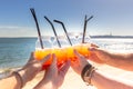 Friends toasting, holding glasses of tropical drink. Lisbon, Portugal. Cheers celebrating friendship