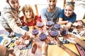 Friends toasting red wine at restaurant bar with open face masks - New normal lifestyle concept with happy people having fun Royalty Free Stock Photo
