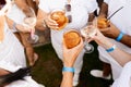 Friends toasting, saying cheers holding tropical blended fruit margaritas. Watermelon and passionfruit drinks